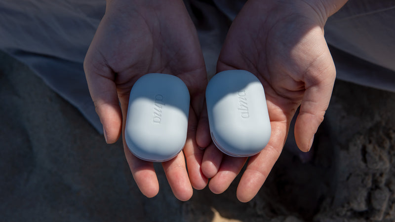 Person holding ALMA EMDR tappers, one in each hand, during a calming session